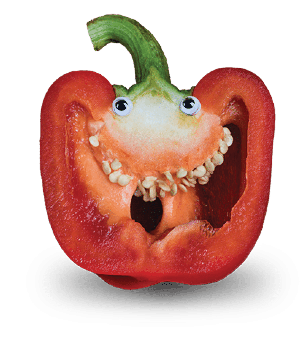 Red Bell Pepper Sliced in Half to Reveal Seeds as Teeth and with Googly Eyes added to imitate a Face