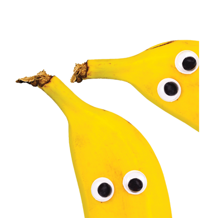 Banner with banana fruits with funny googly eyes on bright blue background with copy space